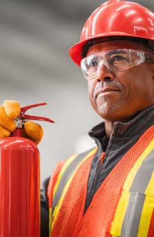 Safety training event for fire prevention industrial facility image of worker warehouse environment close-up view safety awareness